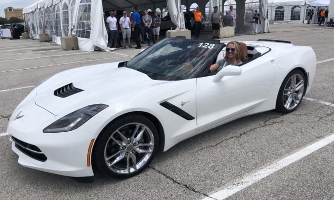 Theresa Belding in a white corvette.