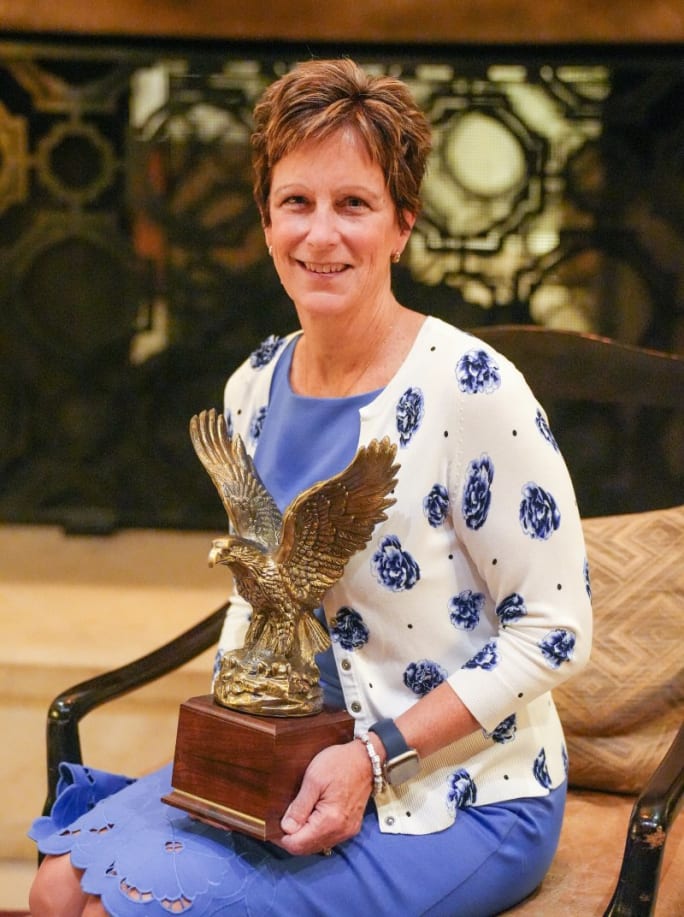 A portrait of Sharon Etherington holding her Fleet Manager of the Year award.
