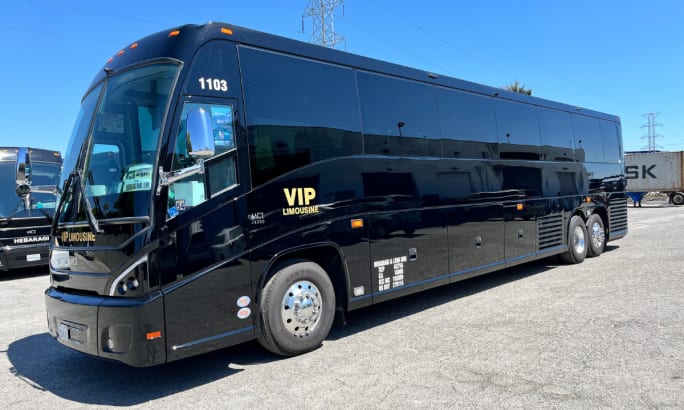 A black MCI J4500 bus.