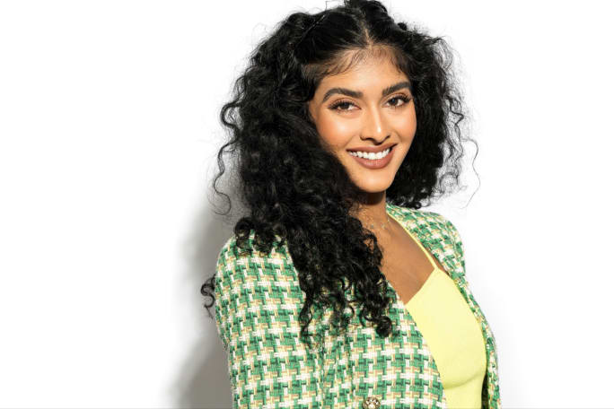 A smiling woman with long dark hair.