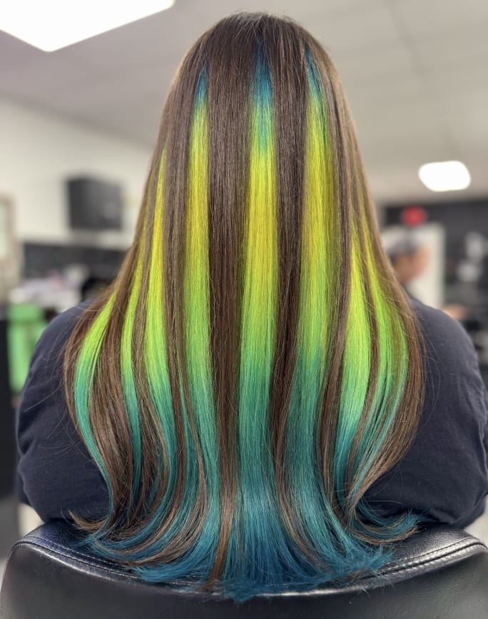 A green and brown striped hair color finish seen from the back.