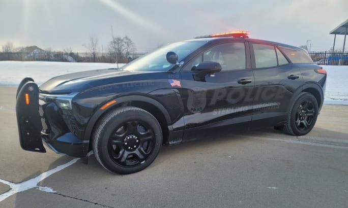 A photo of a black Sterling Heights upfitted police car is shown.
