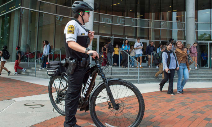 An officer sits on a Trek e-bike on the campus of Virginia Commonwealth University.