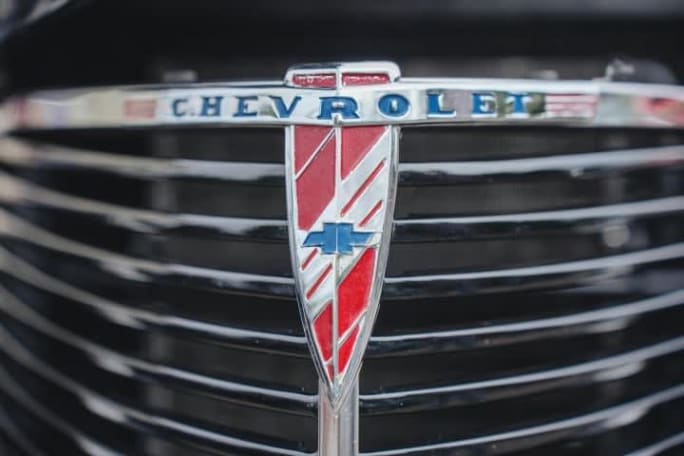 Close-up of a vintage Chevrolet grille and emblem, highlighting classic American automotive design and brand heritage.