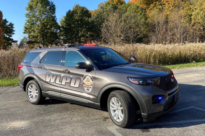 A gray Ford Police Interceptor Utility Hybrid with the the West Lafayette PD badge and 'WLPD' is shown.