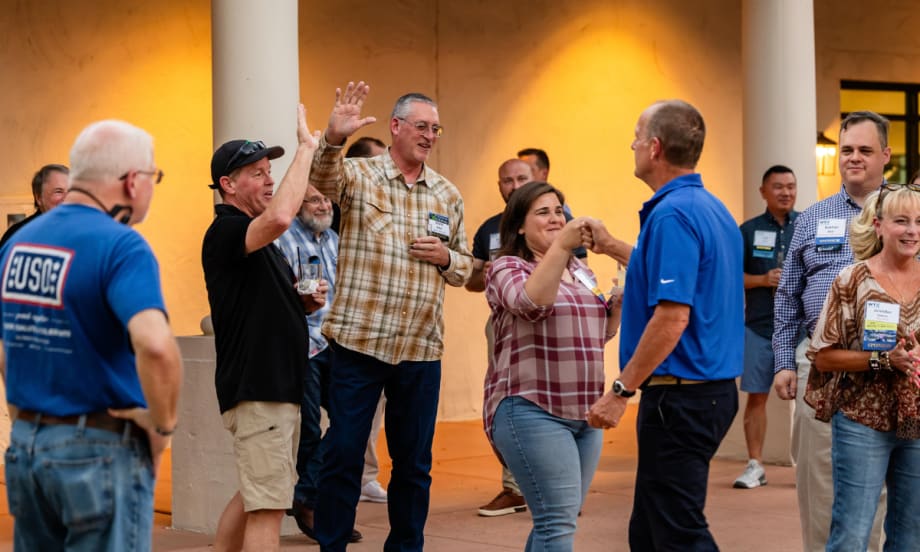 Fleet managers and supplier partners interact during a Work Truck Exchange networking event featuring games and attendee activities.