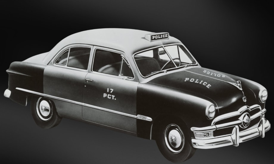 Vintage 1950s Ford police sedan with 17 PCT markings, black and white