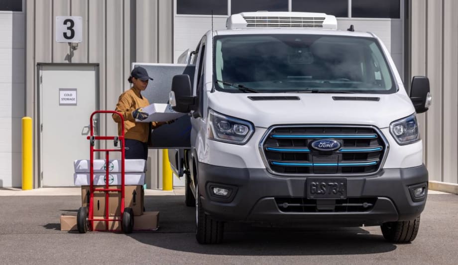 Photo of fleet driver and deliverer loading contents into a Ford E-Transit van.