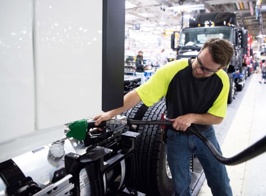 Technician fueling a truck with diesel