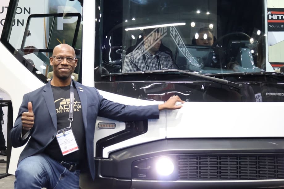 male fleet manager with thumbs up gesture while posing beside a REE P7-C electric truck during Work Truck Week 2024