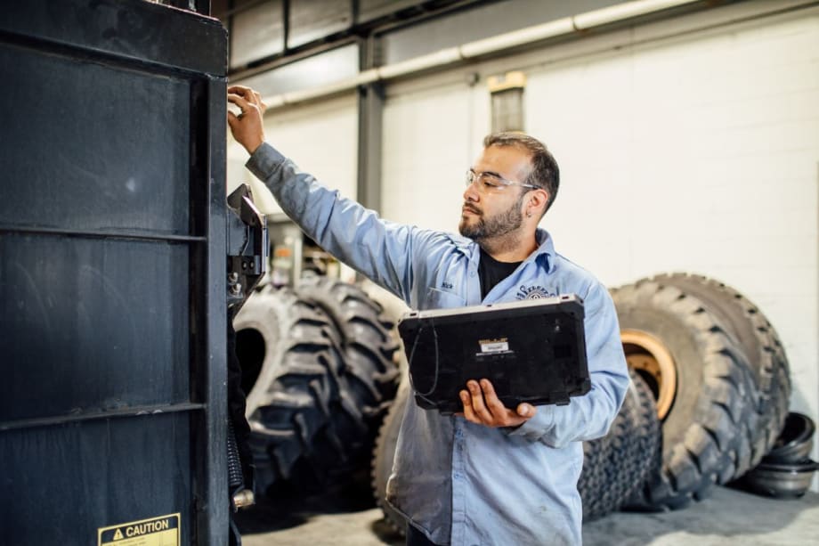 A technician by a work truck