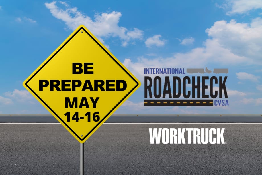 A yellow road sign that says "Be Prepared May 14-16" with International roadcheck logo for CVSA on a road background.