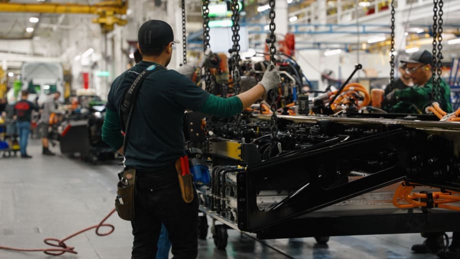 Man at workstation in auto manufacturing facility