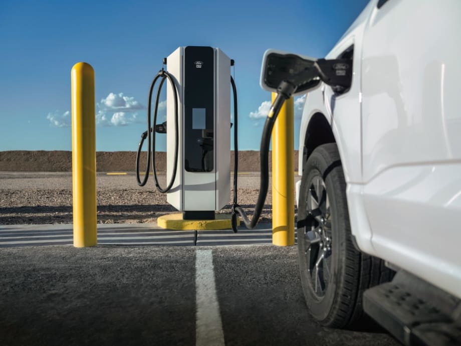 A white Ford electric truck charging