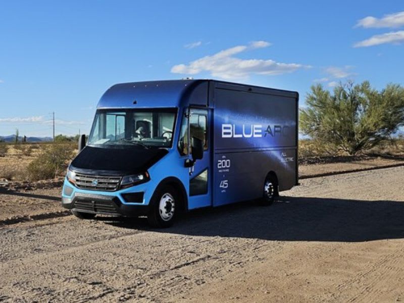 Blue step van facing left.