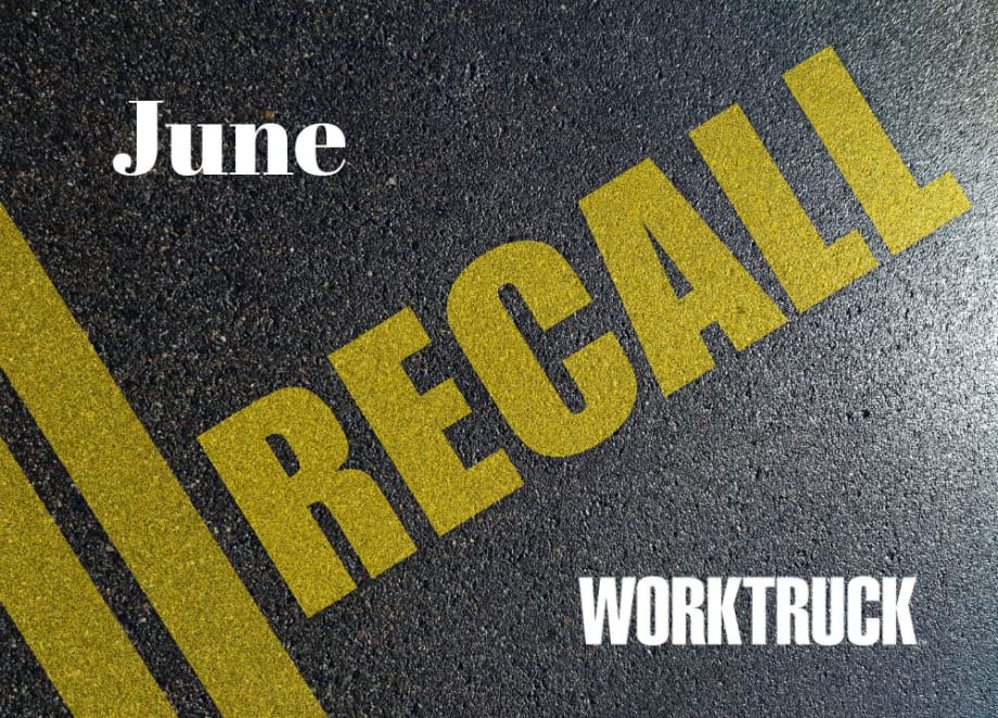 Close up image of a road, with double yellow line angled on the left and yellow lettering that says RECALL.