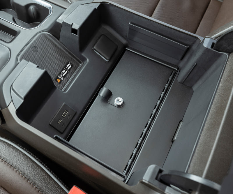 Security safe installed in the center console of a pickup truck.