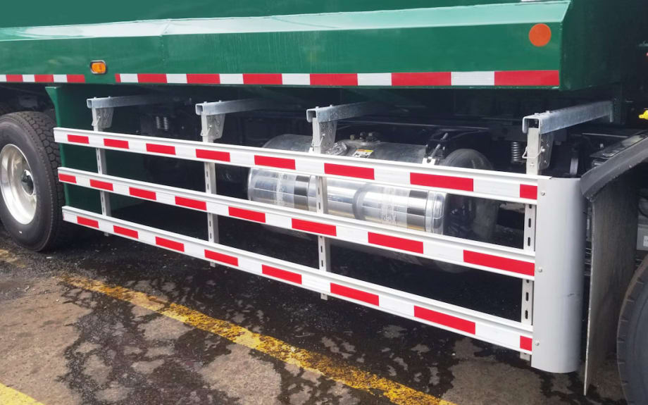 A green truck with a red and white stripe on the side.