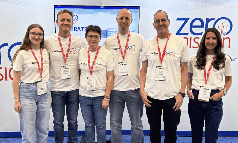 Group of six people standing in front of a ZeroMission background.