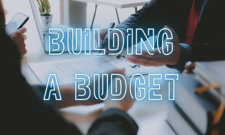 Building a Budget over image of working people at a desk budgeting