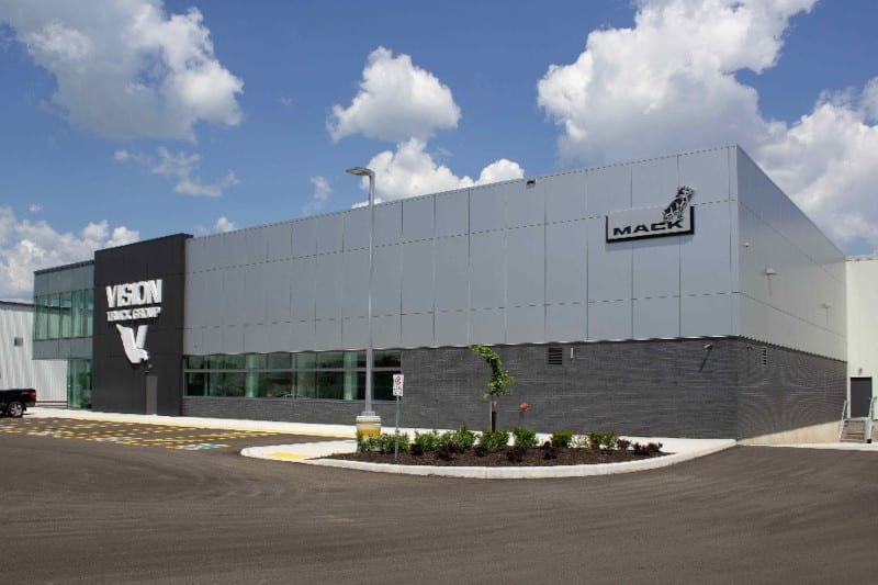 Commercial building with logo for Mack Trucks and Vision Truck Center.