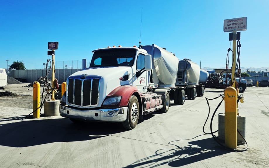 Truck parked with two bulk haul trailers behind it.