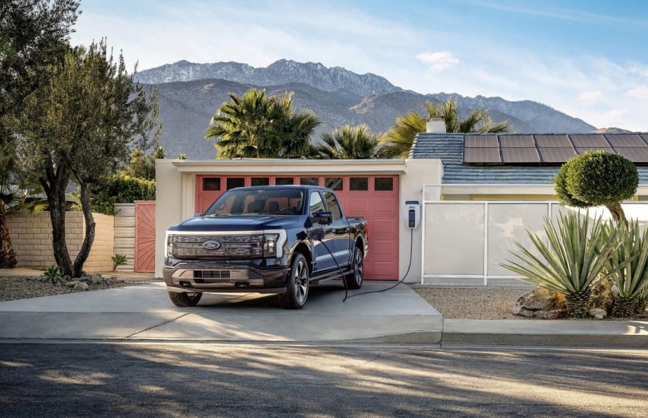 Ford F-150 Pickup Truck Charging outside of a home