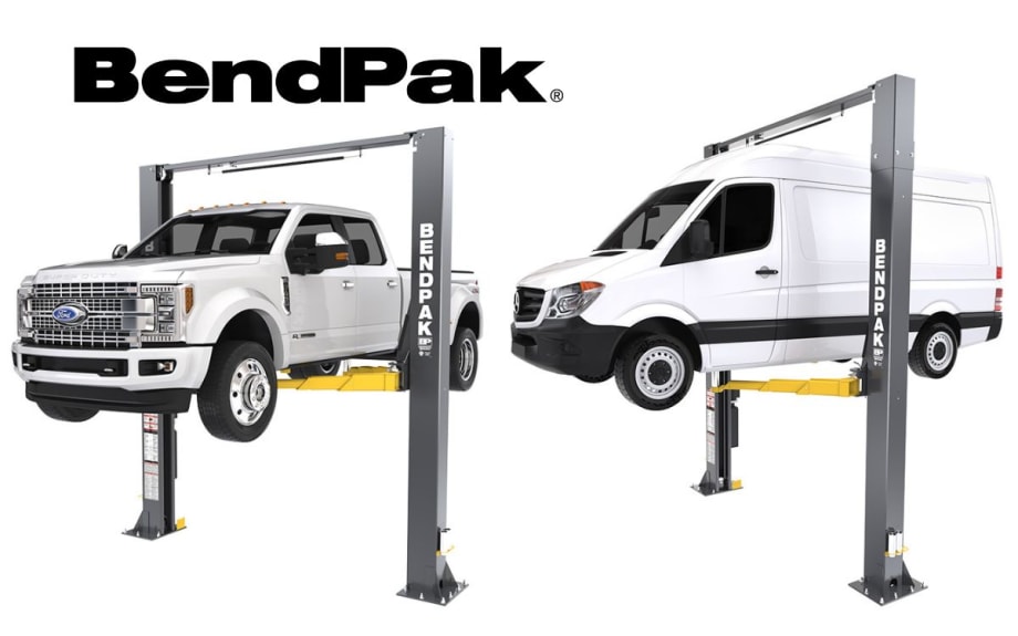 A white pickup truck and a white van each on an automotive lift.