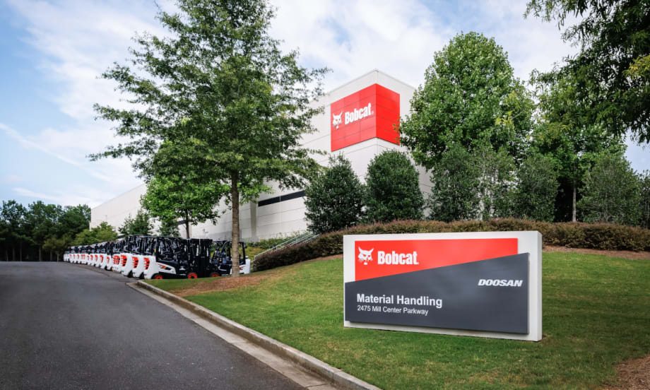 A clear view of the Bobcat factory sign positioned in front of the building, showcasing the brand's industrial presence.