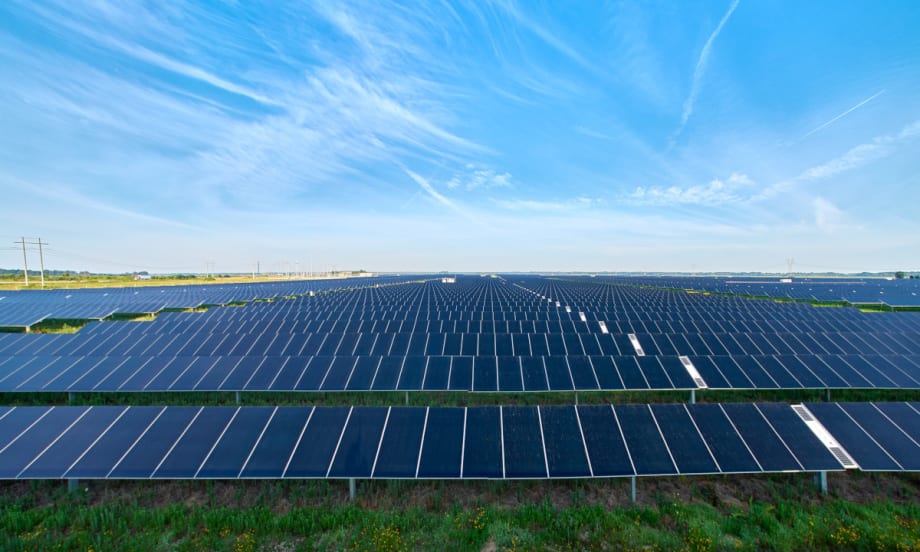 Photo of solar panels and blue sky.