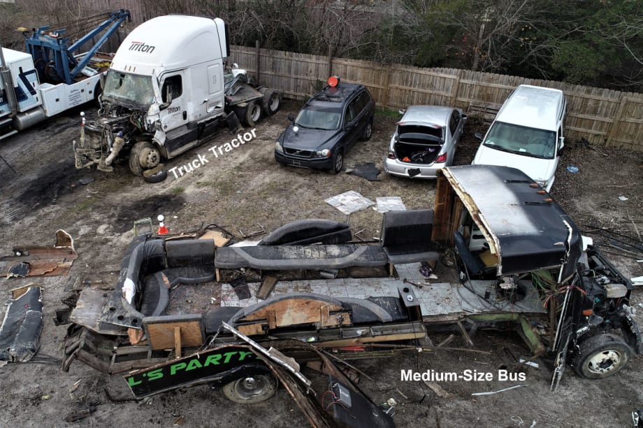 Tow yard photo of truck and bus post-crash