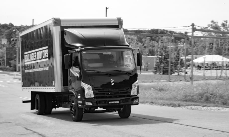 black box truck driving on road