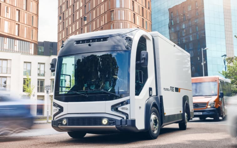 Futuristic-looking box truck driving down a street.