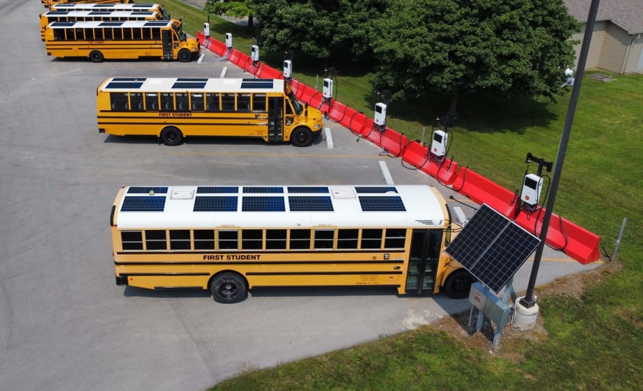 school buses with solar panels at charging stations