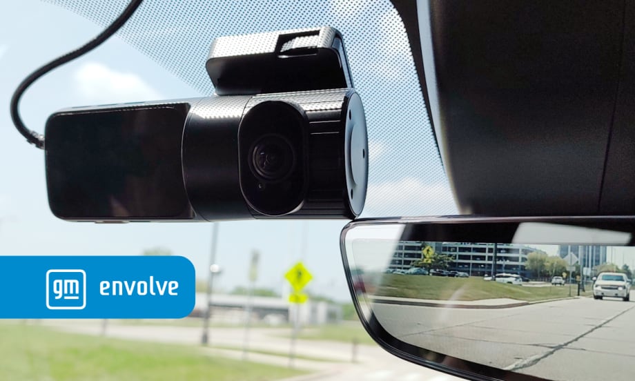 photo of a dashcam mounted adjacent to mirror inside a pickup truck