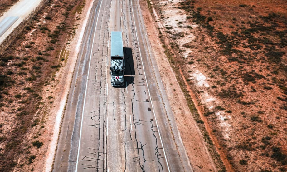 Overhead photo of tractor trailer traveling on a closed section of highway.