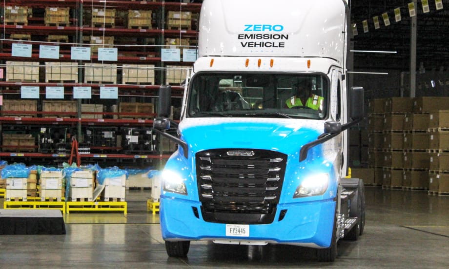 Photo of a Freightliner eCascadia truck facing the camera inside a warehouse.