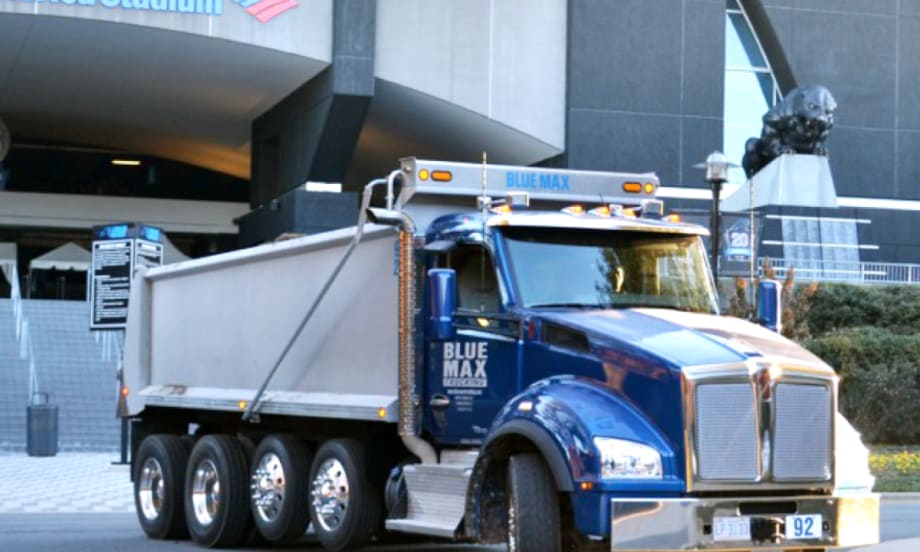 Photo of blue dump truck.