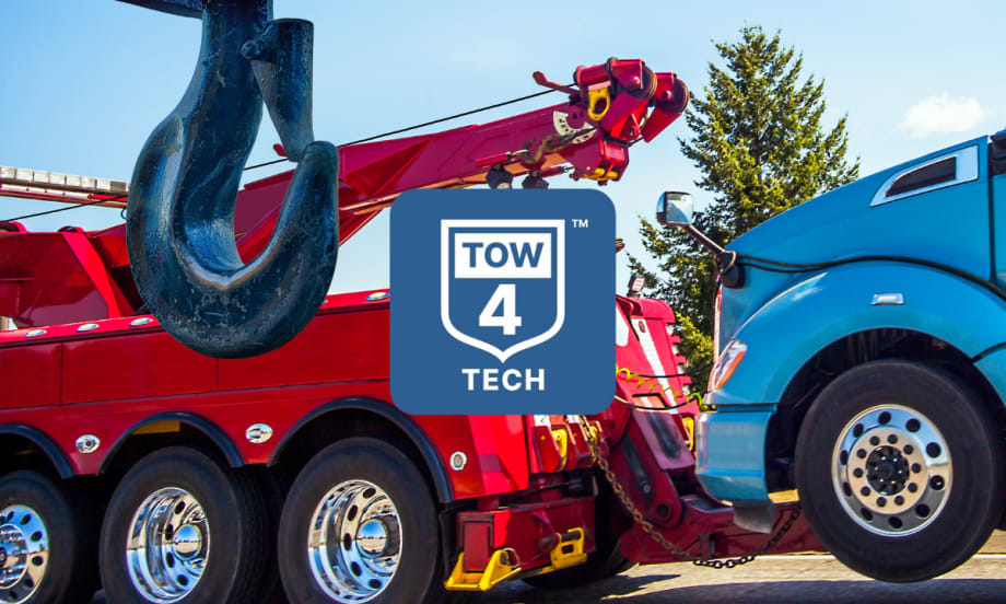 Tow truck towing a big rig with Tow4Tech logo