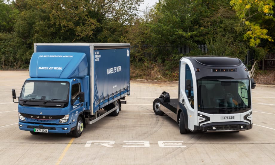 A box truck and a chassis cab truck parked facing forward, photographed from high angle in front of the trucks.