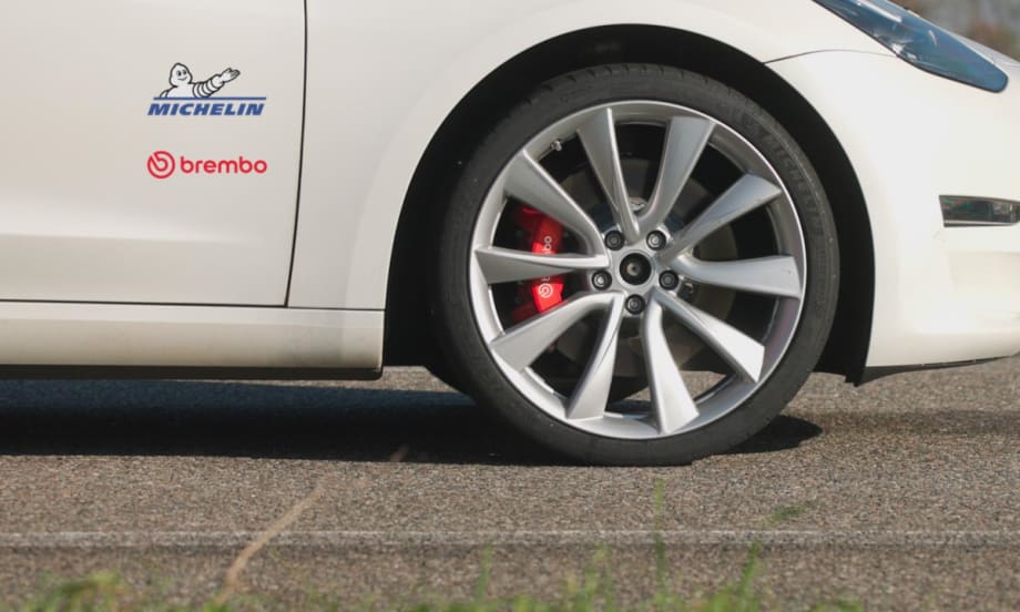 Photo of wheel of car and brakes with logos on car for Michelin and Brembo.