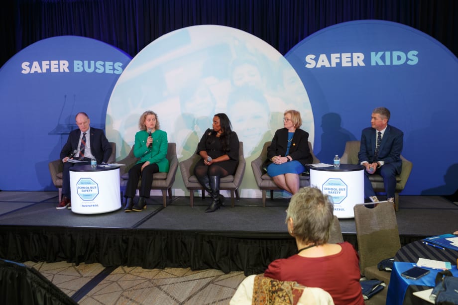 A panel of people on a stage.