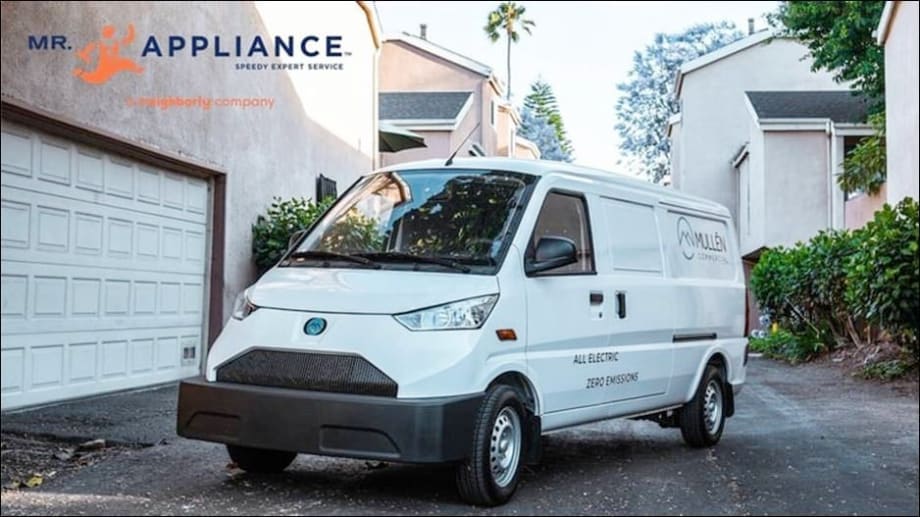 White electric van parked outside a home.