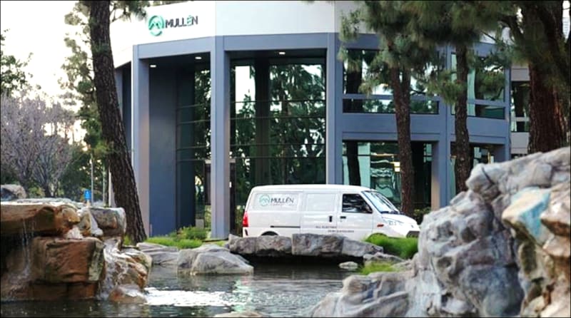 Image of an EV van parked in front of Mullen Automotive headquarters.