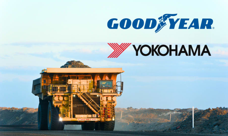 Large mining dump truck driving and logos against a blue sky for Goodyear and Yokohama.