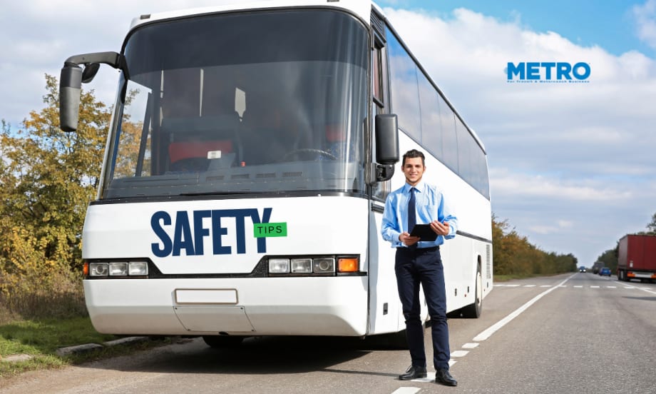 Bus driver standing in front of a bus