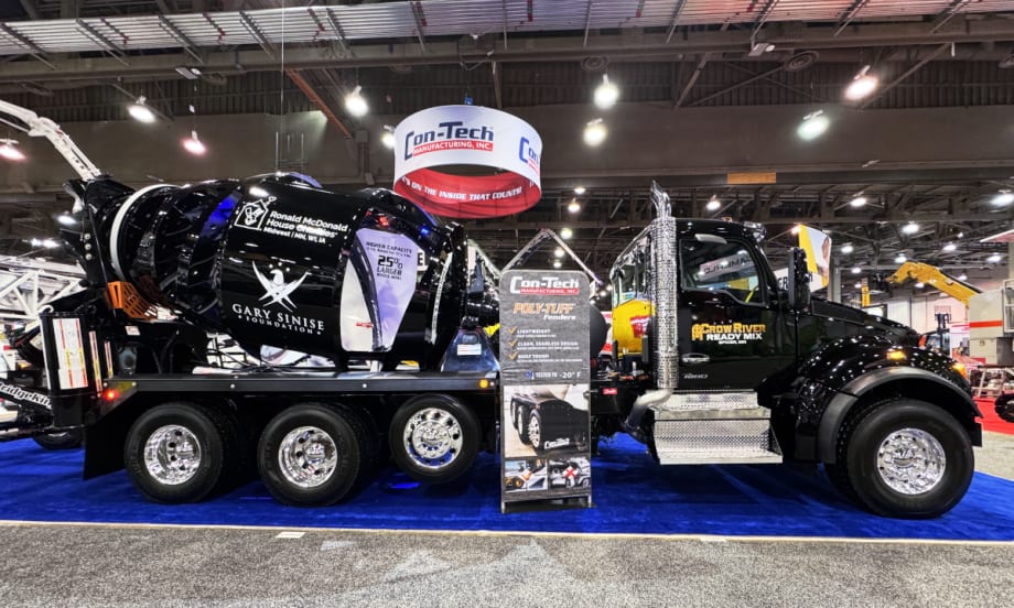 side photo of a black concrete truck