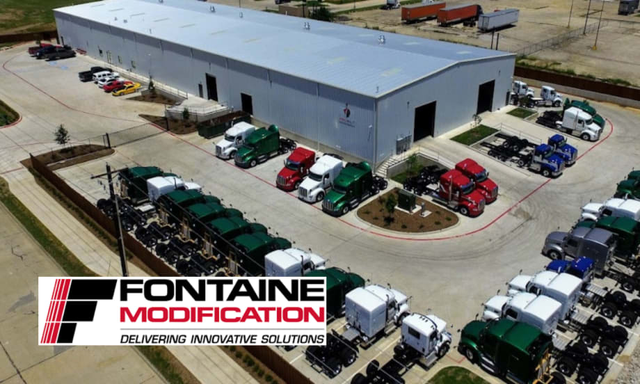 Aerial photo of a truck modification garage and trucks in the parking lot.