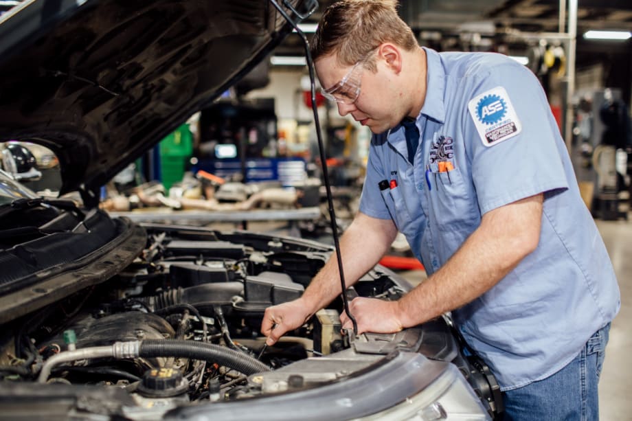ASE technician working on a vehicle