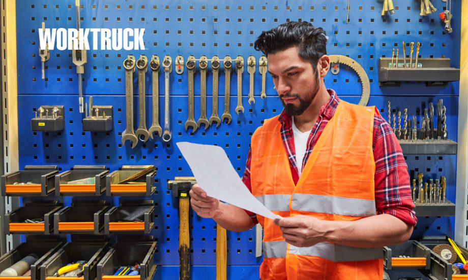 Technician in front of tools looking at a work order